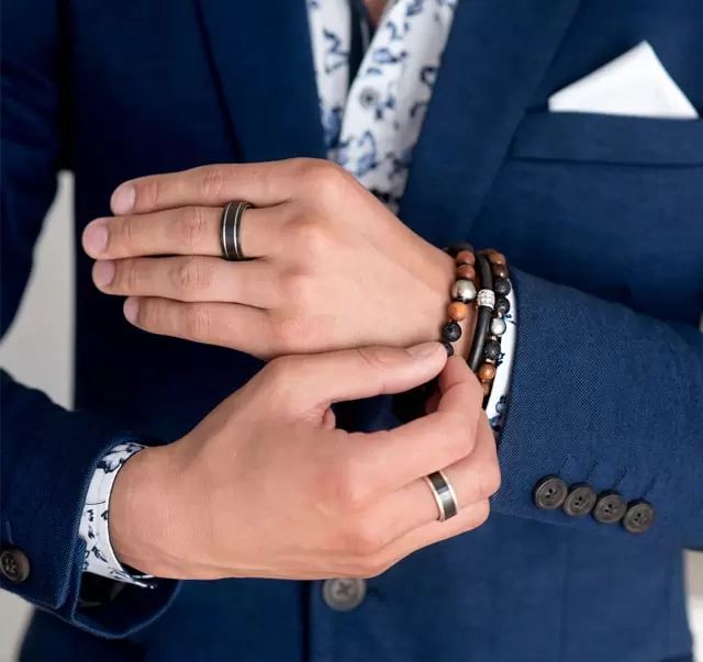 a mans hand with men's jewellery on it